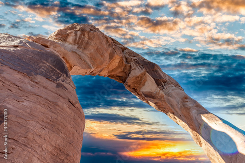 Skyward view of Delicate Arch, Arches National Park. Rock formation and blue sky