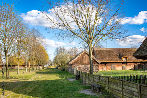 Traditional old polish countryside wooden thatched houses and farmyards.. Dziekanowice, Poland. photo