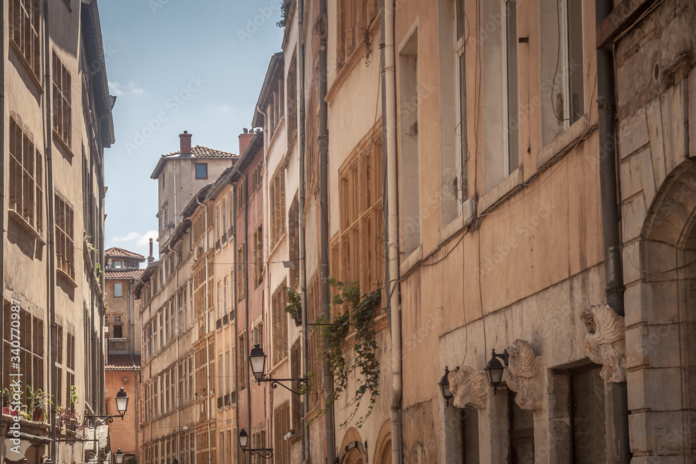 Typical narrow street of the Vieux Lyon (old Lyon) on the Presqu'ile district with its traditional architecture during a sunny summer afternoon. Lyon is the seccond biggest city of France