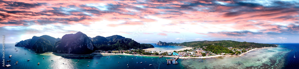 Panoramic aerial view of Tonsai Pier and Phi Phi Don coastline at sunset, Thailand