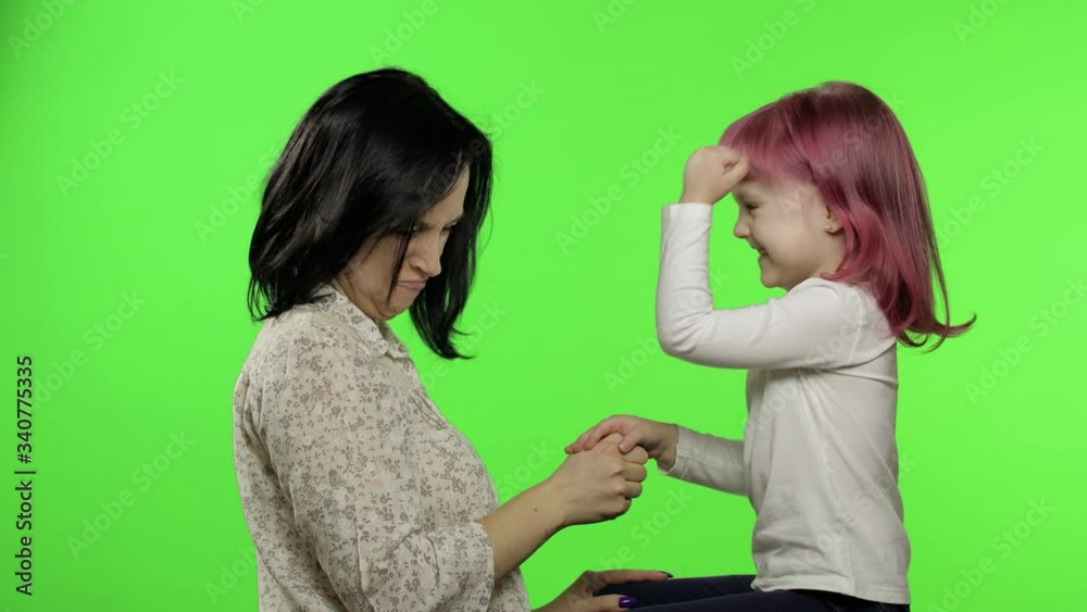 Mother and little daughter playing rock paper scissors. Chroma Key. Leisure game Mother and little daughter playing rock paper scissors. Chroma Key. Leisure game