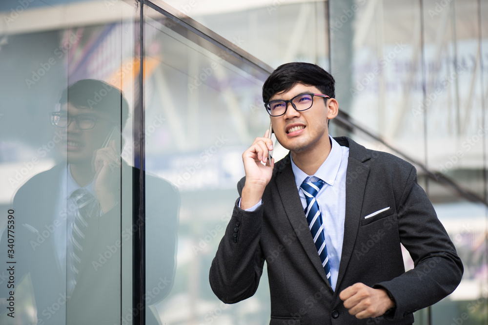 Young businessman running while talking on the mobile phone during rush hour. Business rushing concept. Young businessman running while talking on the mobile phone during rush hour. Business rushing concept.