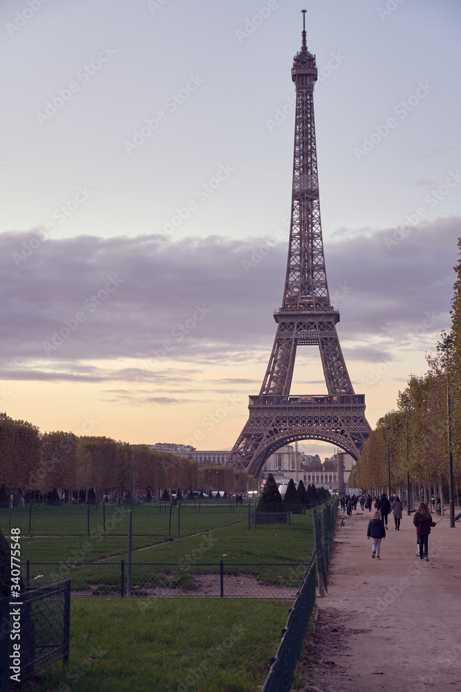 View of Champ de Mars and the Eiffel Tower on a sunset. Paris, France. Copy space.