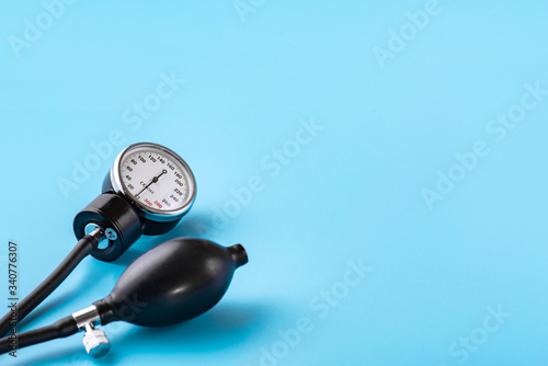 Device for measuring blood pressure. Tonometer, cuff, stethoscope on a blue background. Copy-space.