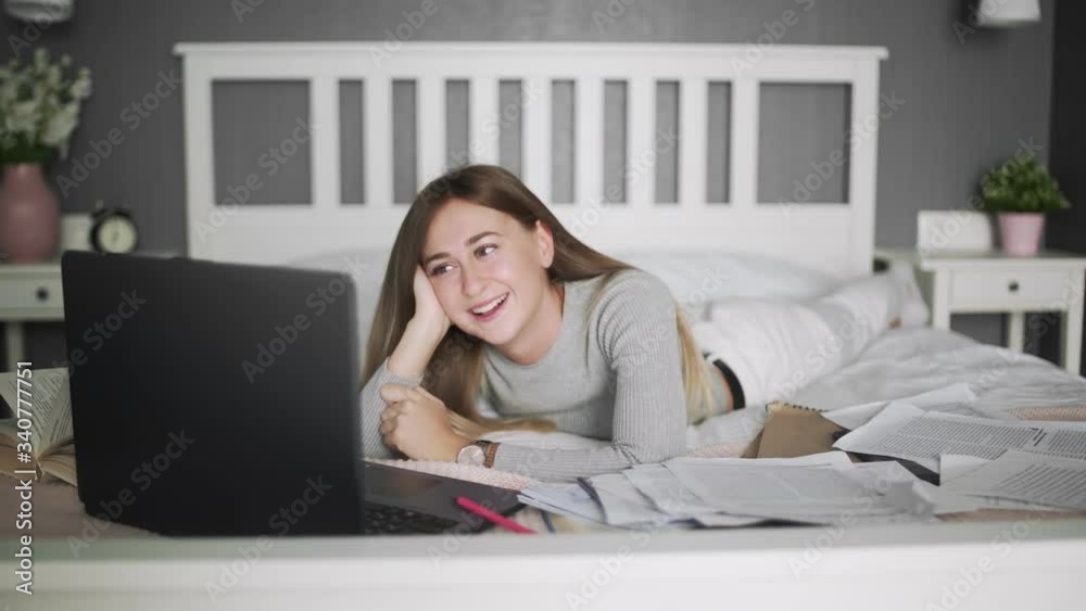 Female freelancer lying on the bed and watch a fanny video in her timeout Female freelancer lying on the bed and watch a fanny video in her timeout