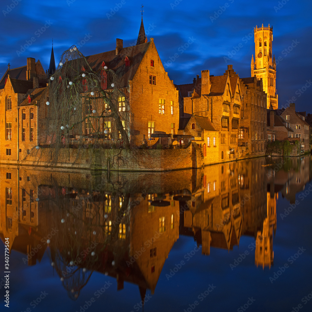 Obraz Square cityscape reflection of Bruges with its belfry and canals at night during the blue hour, Belgium.
