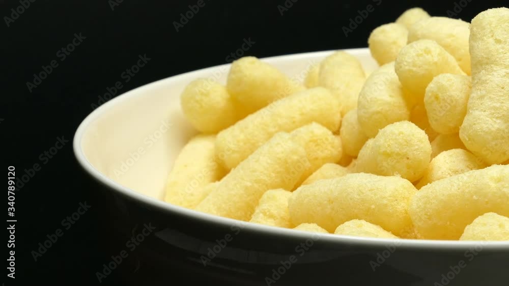 Rotating Close Up Of Sweet Corn Sticks On A White Bowl On A Black Background. Rotating Close Up Of Sweet Corn Sticks On A White Bowl On A Black Background.