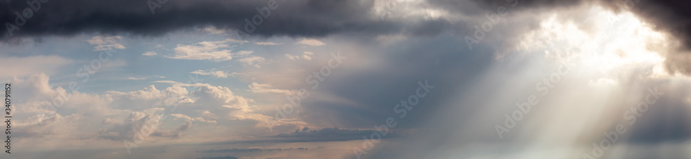 Beautiful Panoramic View of Cloudscape during a colorful sunset or sunrise. Taken in Israel. Dramatic Sunrays. Nature Background