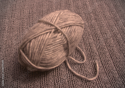 Ball of wool with grey wool background.
