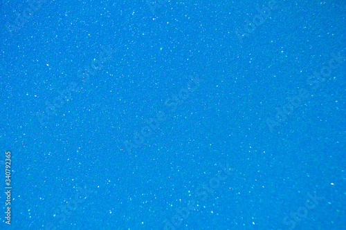 Sparkling sky blue glitter texture background with defocused bokeh