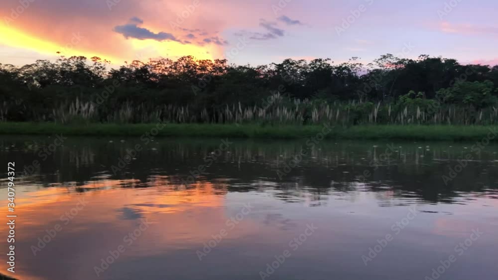 Sunset in Amazonas from a canoe, with nice clouds. Sailing during the sunset with a canoe on the amazon river. Sunset in Amazonas from a canoe, with nice clouds. Sailing during the sunset with a canoe on the amazon river.