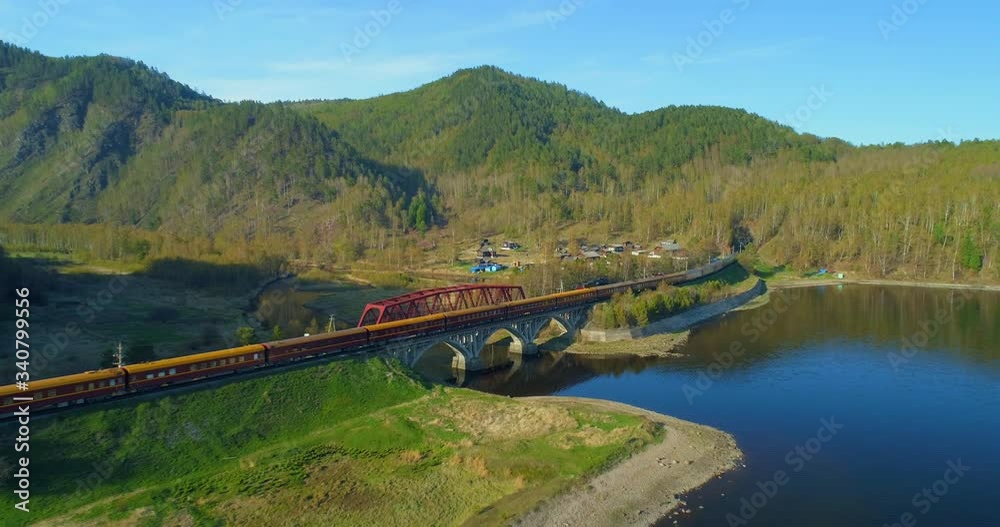 Aerial Forward: Bright Sunny Day at the Relaxing Lake While a Trains Stops in the Area - Lake Baikal, Russia Aerial Forward: Bright Sunny Day at the Relaxing Lake While a Trains Stops in the Area - Lake Baikal, Russia