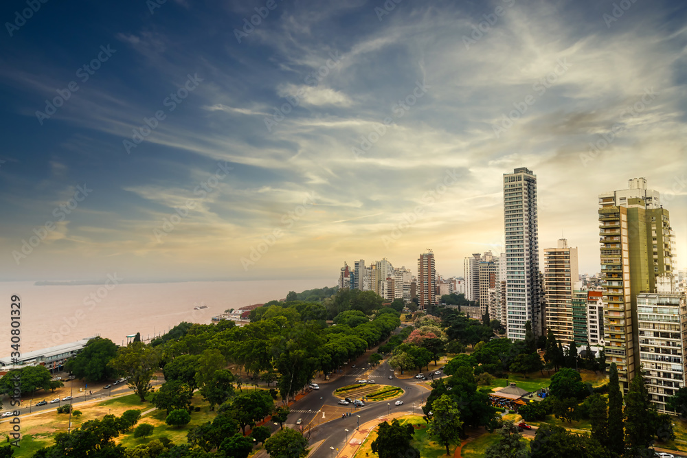 Fototapeta premium Panoramic view of the city of Rosario (Argentina) along the Parana river during sunset