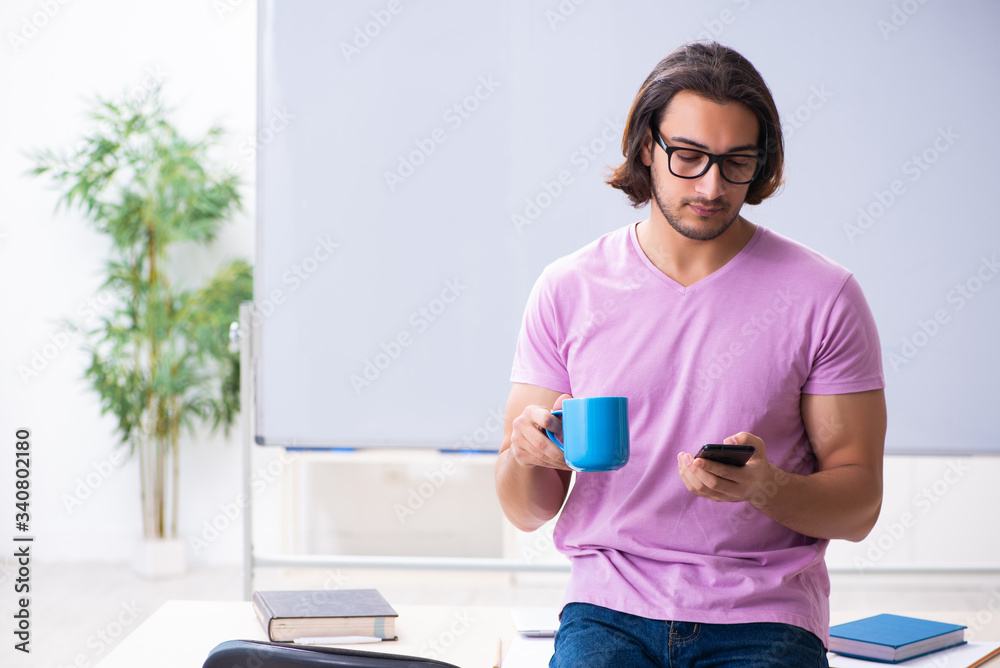 Young male student preparing for exams at classroom Young male student preparing for exams at classroom