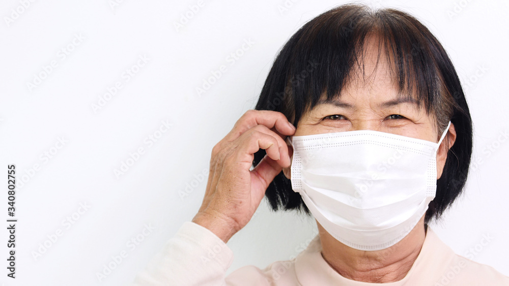Close up Face of Asian elderly woman wearing medical face mask for virus protection