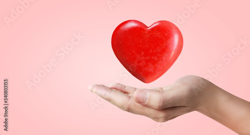 Hands holding red heart. heart health. and donation concepts