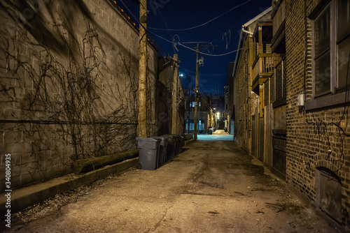 Dark and eerie urban city alley at night 