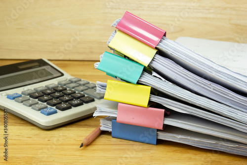 file folder and Stack of business report paper file with  Calculator on the table in a work office  concept document in work office