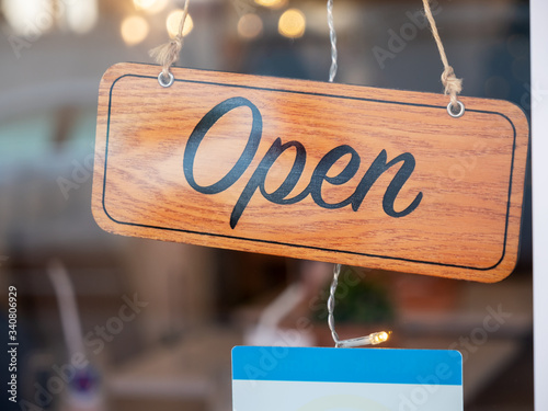 open sign board through the glass of store window