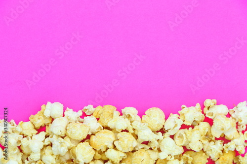 Salted popcorn mix with cheese popcorn frame on pink paper background, have copyspace for put text
