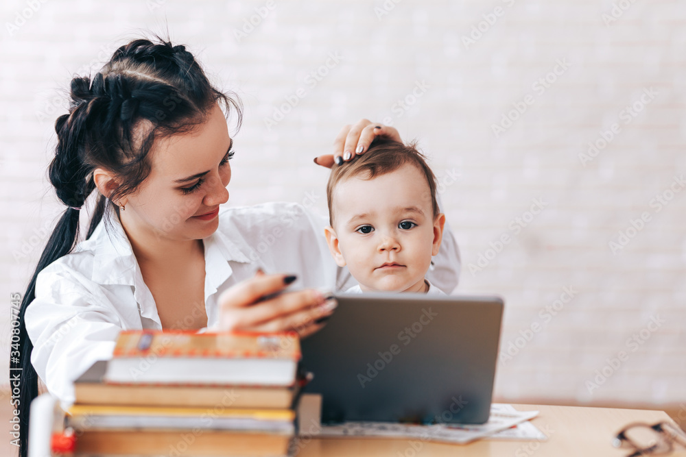 Happy mother and son watch educational videos, mother and son talk on video calls, the teacher deals with the child, educational games, quarantine Happy mother and son watch educational videos, mother and son talk on video calls, the teacher deals with the child, educational games, quarantine