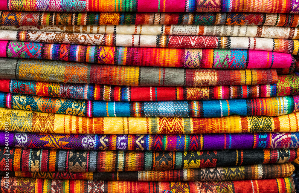 A pile of colorful Andean fabrics on the poncho market of Otavalo, Quito Region, Ecuador. A pile of colorful Andean fabrics on the poncho market of Otavalo, Quito Region, Ecuador.