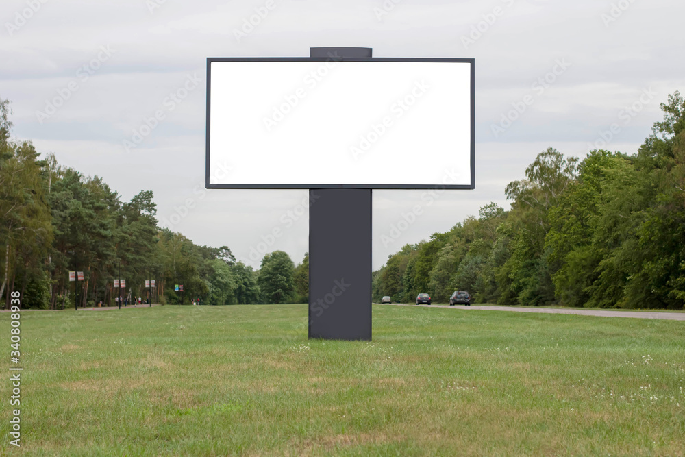 Blank white billboard for advertising on background of trees and sky. Place for text Blank white billboard for advertising on background of trees and sky. Place for text