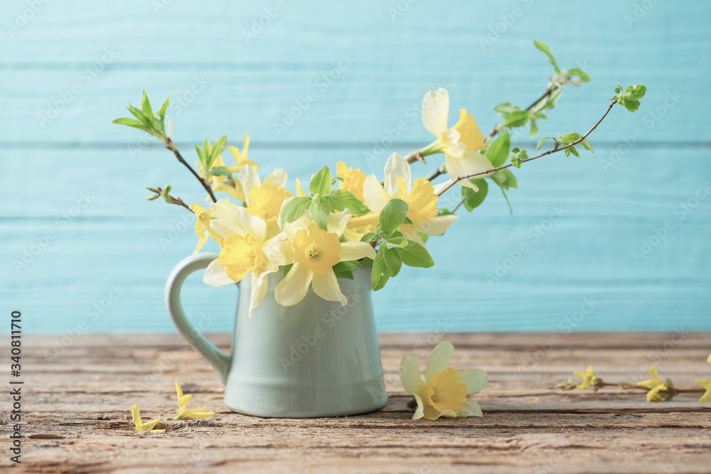yellow spring flowers on old wooden background