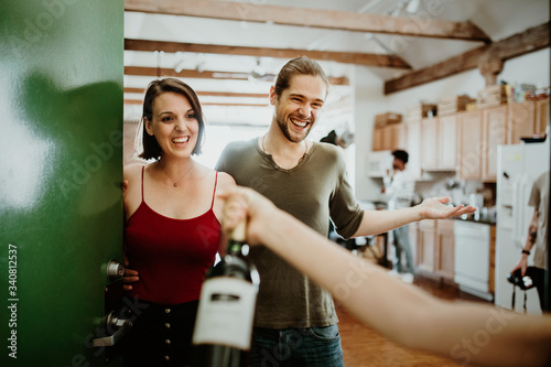 Guest giving a housewarming gift photo