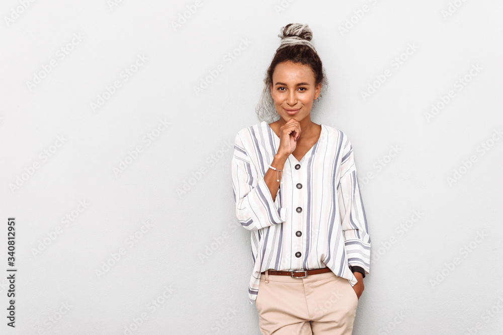 Pleased optimistic happy young african business woman with dreads isolated over white wall background. Pleased optimistic happy young african business woman with dreads isolated over white wall background.