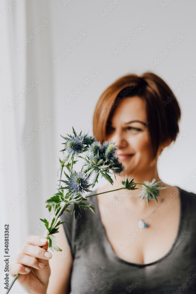 Woman holding beautiful flowers Woman holding beautiful flowers