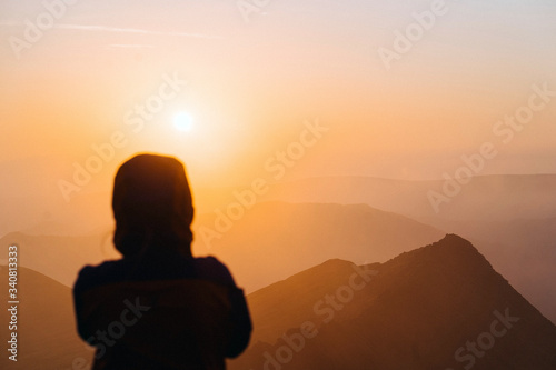 Traveler watching the sunrise