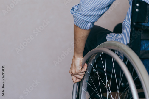 Unrecognizable disabled woman in wheelchair at home. Recovery and healthcare concepts.