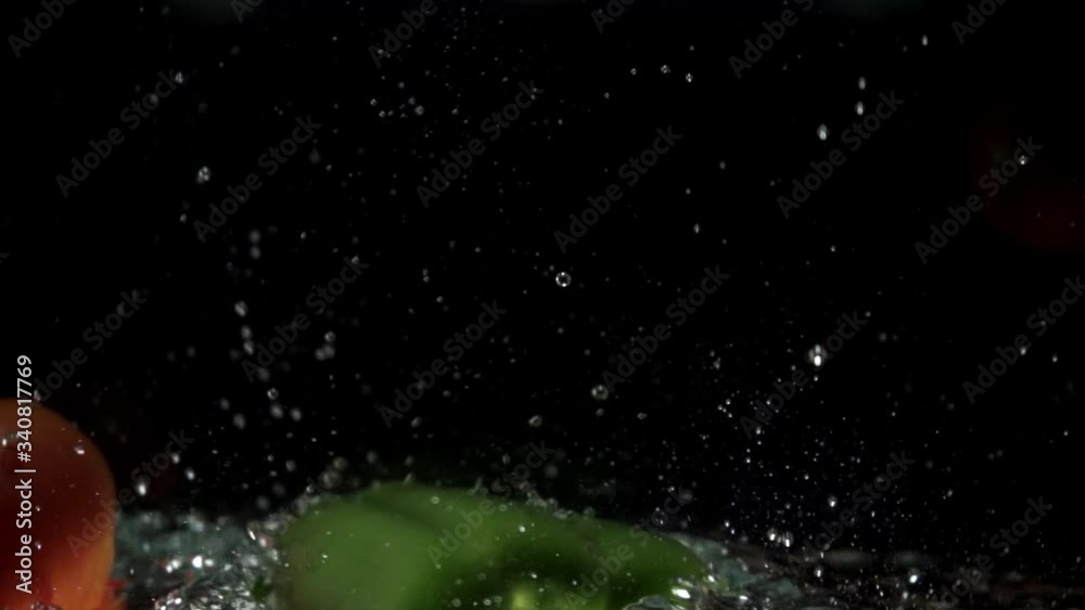 tomato and pepper are dipped in water