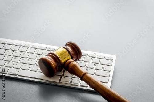 Judge hammer, keyboard on grey lawyer's desk space for text