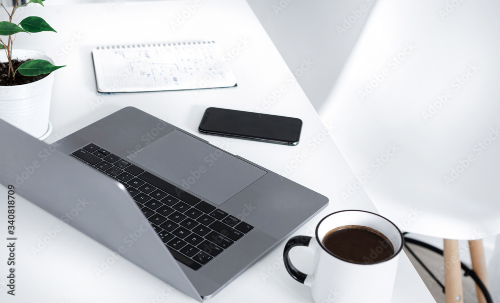 Home office with computer, notepad, cup of coffee and smartphone. Remote work or online learning concept Home office with computer, notepad, cup of coffee and smartphone. Remote work or online learning concept