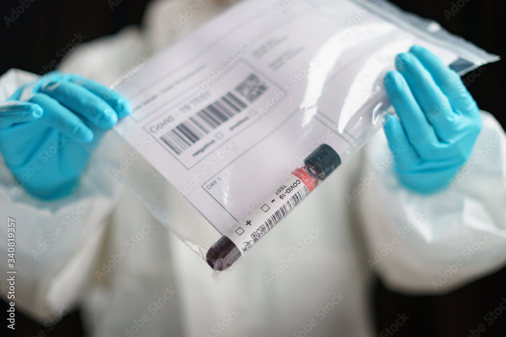 Coronavirus testing, a hand holds transparent bag with tube of blood test samples of coronavirus (COVID-19).