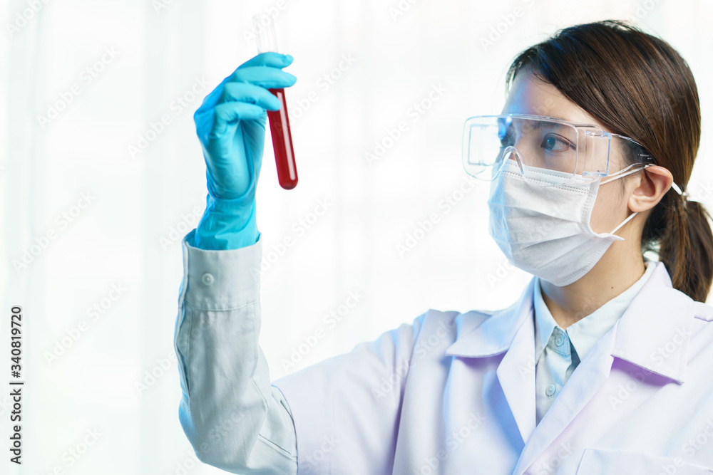 Medical equipment, Hand holding a test tube filled with blood. Medical equipment, Hand holding a test tube filled with blood.