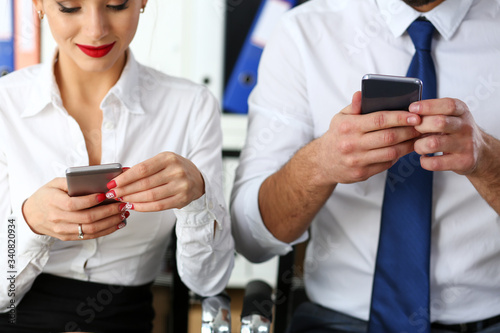 Group of people look at phones in arms at office closeup. Read news mania send sms chat addict use electronic bank modern lifestyle idea job plan colleague share blog tweet web search concept