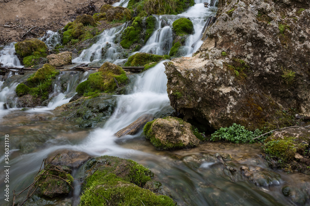 City Cesis, Latvia. Old waterfall with green moss and dolomite rocks.