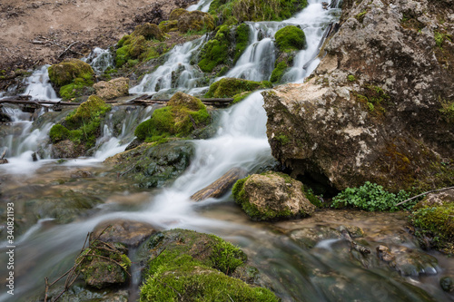 City Cesis  Latvia. Old waterfall with green moss and dolomite rocks.