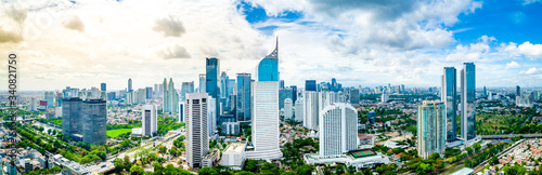 Aerial View of Jakarta Downtown Skyline with High-Rise Buildings With White Clouds and Blue Sky, Indonesia, Asia