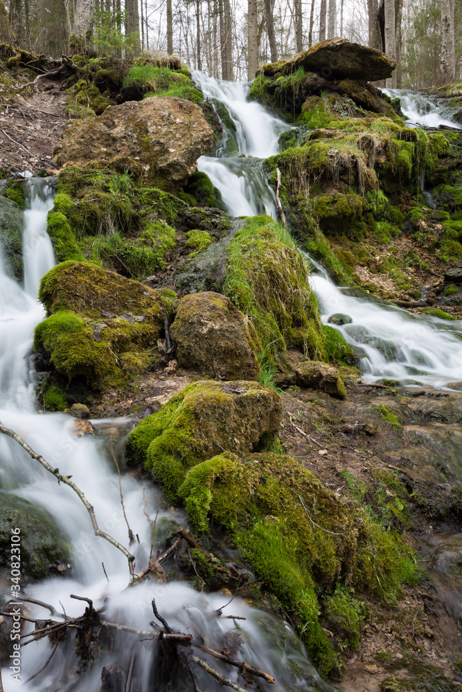 City Cesis, Latvia. Old waterfall with green moss and dolomite rocks.