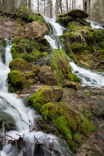 City Cesis, Latvia. Old waterfall with green moss and dolomite rocks.