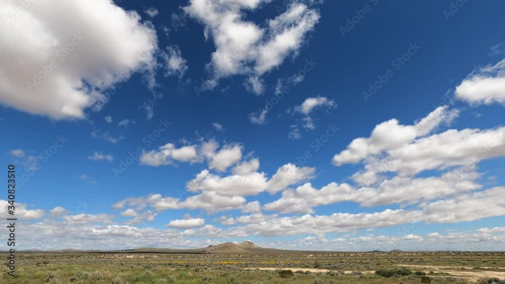 Clouds Blown By The Wind Over The Green Desert Land In California City On A Sunny Day - Timelapse Clouds Blown By The Wind Over The Green Desert Land In California City On A Sunny Day - Timelapse
