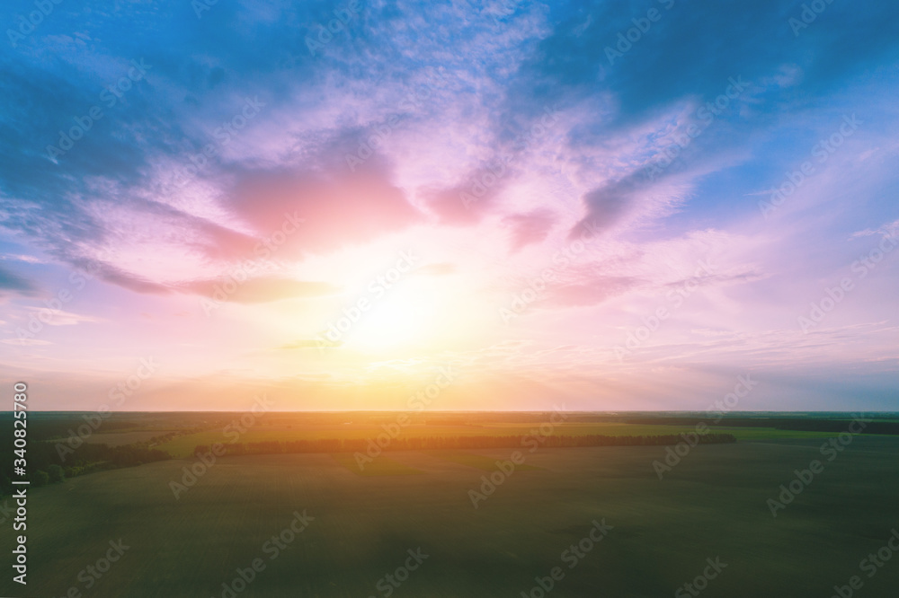 Sunset over the countryside. Colorful cloudy sky at sunset. Gradient color. Sky texture, abstract nature background