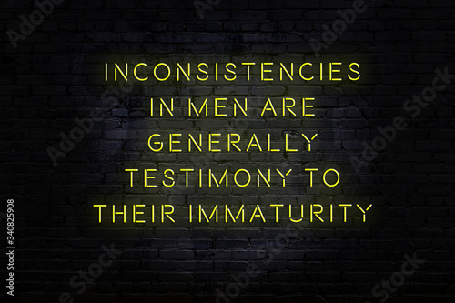 Smart and motivational quotation. Neon sign on brick wall