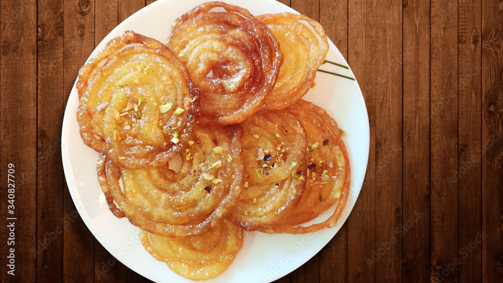 Home Made Jalebi - An Indian Sweet on Wooden Table Home Made Jalebi - An Indian Sweet on Wooden Table