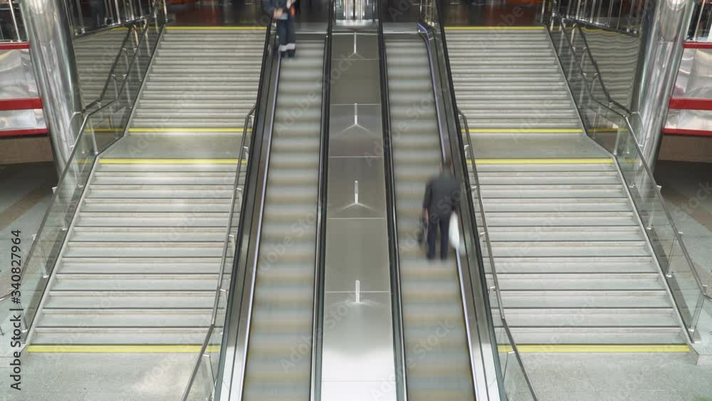Crowd of people in motion on train station, a large number of people move along escalators and stairs, timelapse. Crowd of people in motion on train station, a large number of people move along escalators and stairs, timelapse.