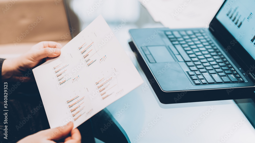 Statistics, data analysis report. Cropped shot of business man working with laptop and graphs. Statistics, data analysis report. Cropped shot of business man working with laptop and graphs.